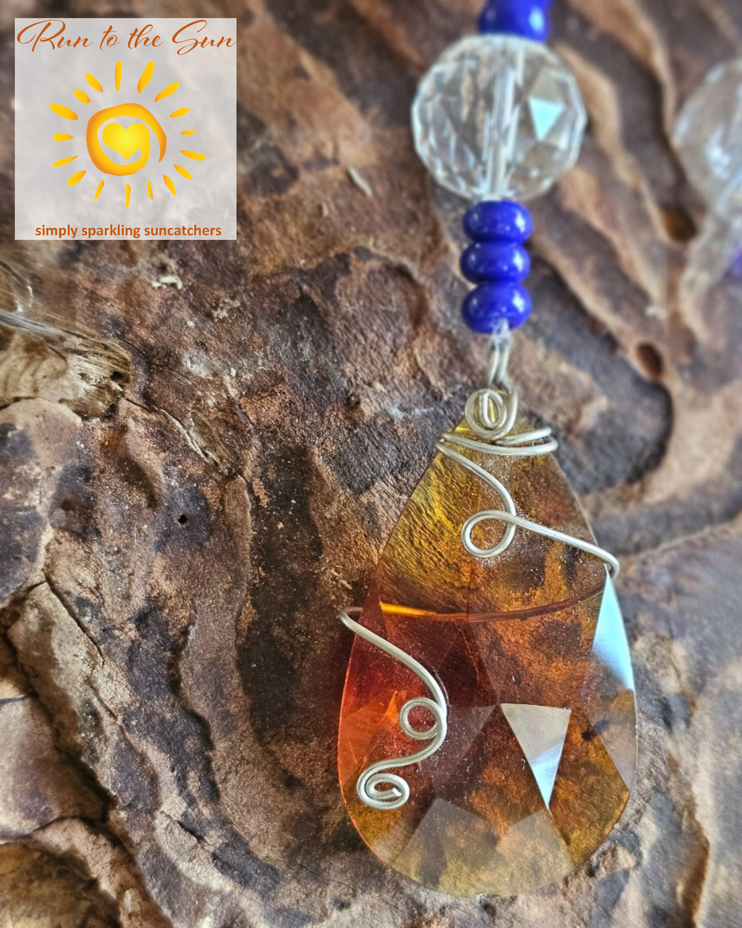 Amber wire-wrapped pendant with blue and amber glass beads with faceted glass highlights detail
