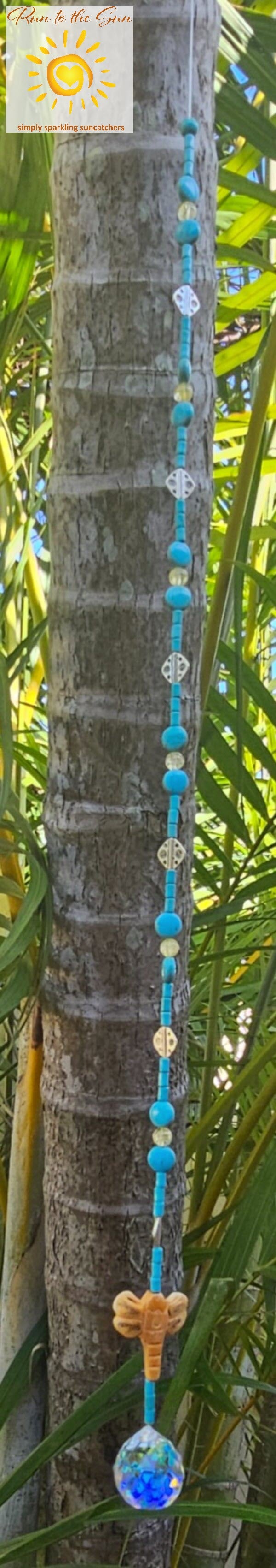 Bone dragonfly pendant with turquoise beads and silver accents hanging view