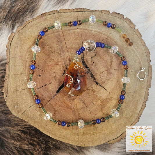 Amber wire-wrapped pendant with blue and amber glass beads with faceted glass highlights